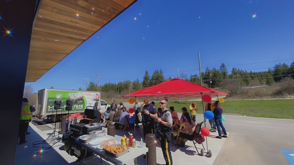 Picture of RCMP officers attending a community bbq with members of the Lower Kootenay Band
