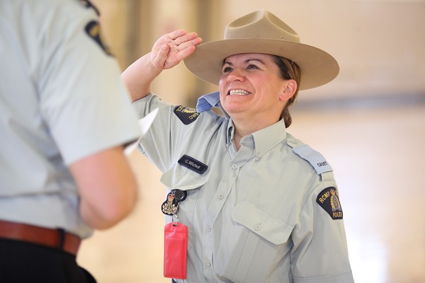Cadet Mitchell smiles while saluting her drill instructor