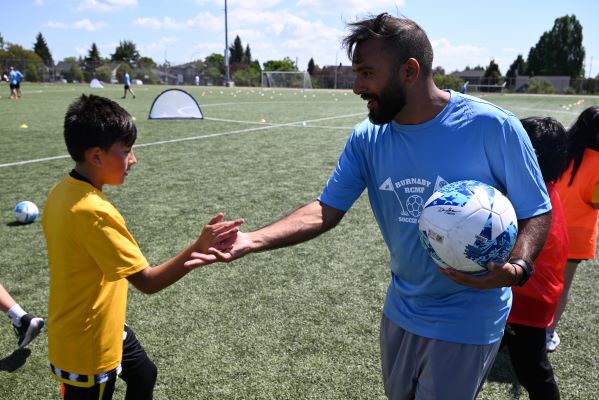 Smiling children with a soccer ball